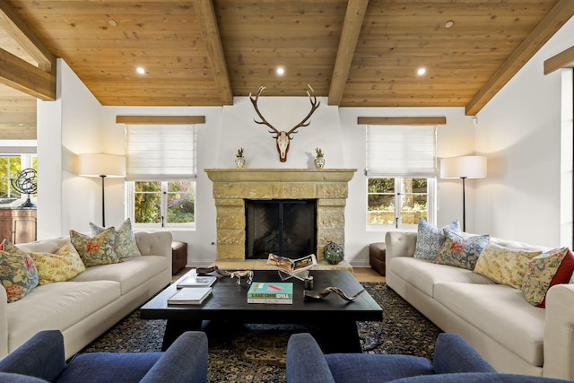 living room featuring vaulted ceiling with beams, plenty of natural light, wooden ceiling, and a fireplace