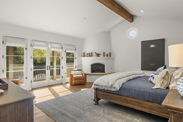 bedroom with light hardwood / wood-style floors, access to exterior, and multiple windows