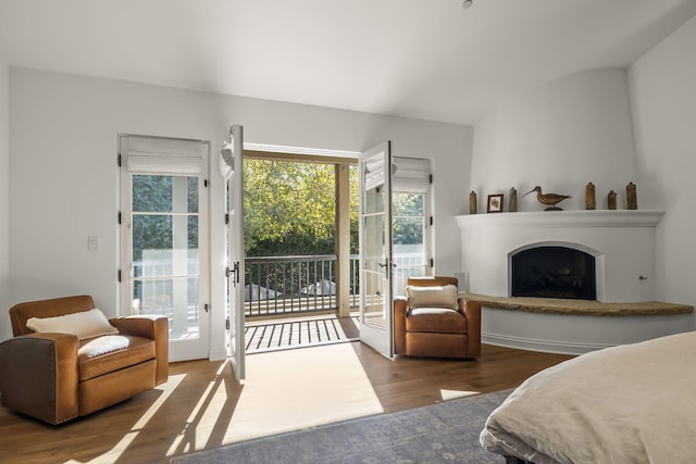 bedroom featuring access to exterior and hardwood / wood-style floors