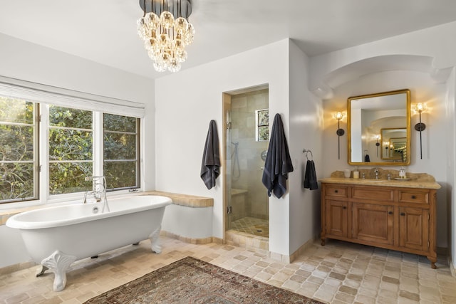 bathroom with vanity, shower with separate bathtub, and a chandelier