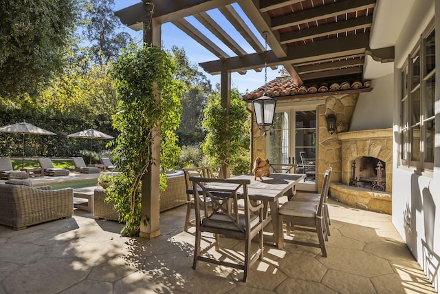 view of patio / terrace featuring an outdoor stone fireplace and a pergola