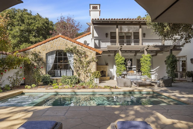 back of house with a balcony and a patio area