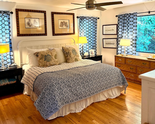 bedroom with ceiling fan and light hardwood / wood-style flooring