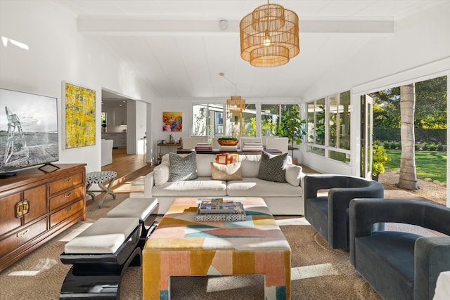 sunroom / solarium with a notable chandelier, lofted ceiling with beams, and a healthy amount of sunlight