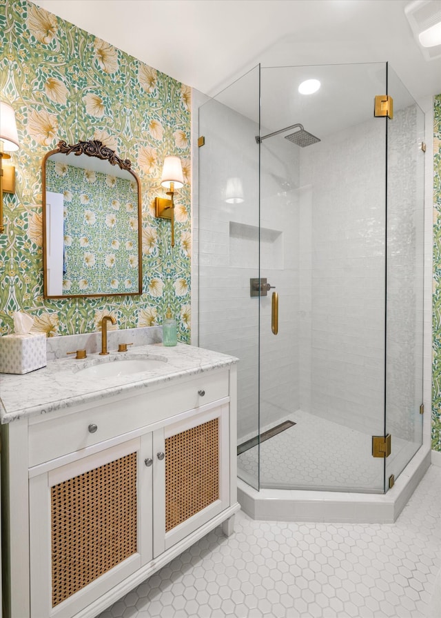 bathroom with walk in shower, tile patterned flooring, and vanity