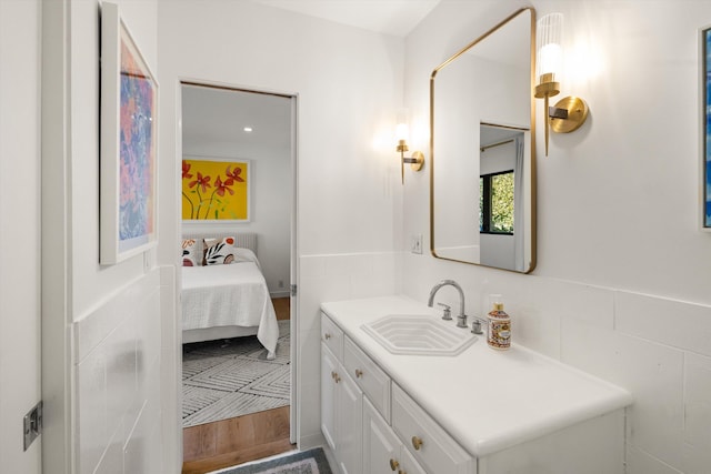 bathroom featuring tile walls and vanity