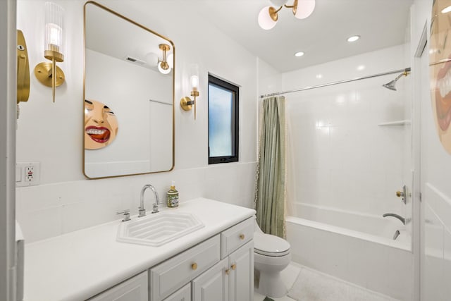 full bathroom with toilet, vanity, tile walls, and shower / tub combo with curtain