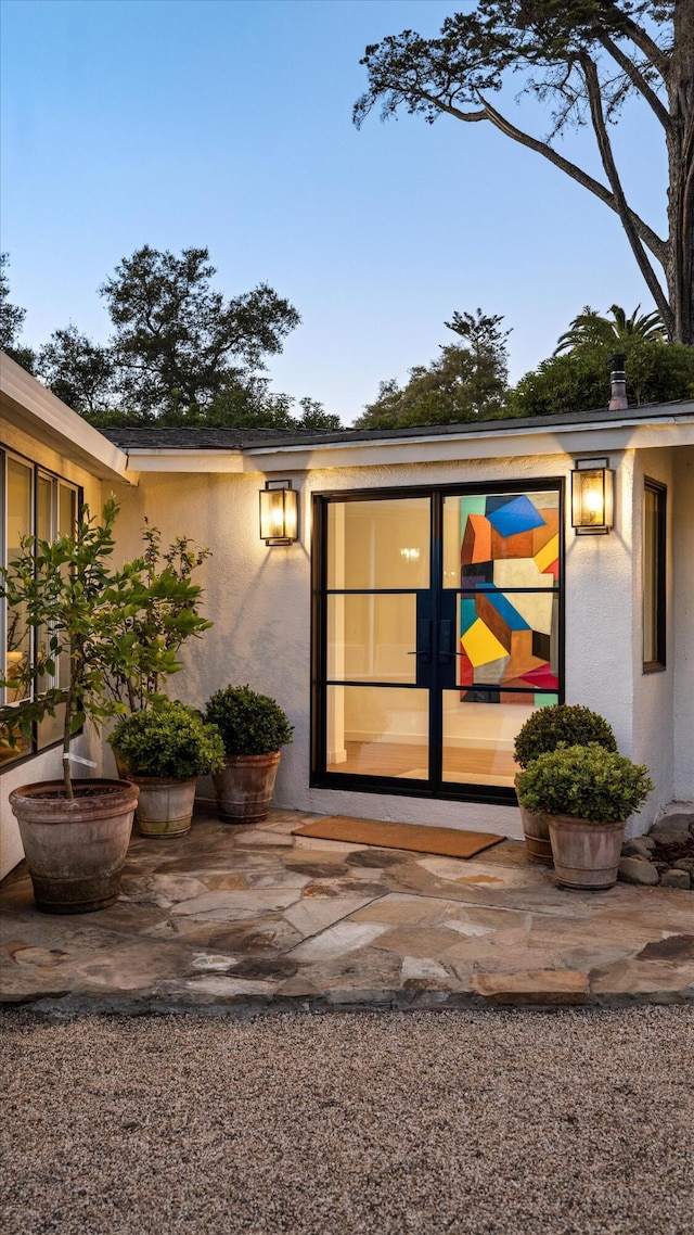 entrance to property featuring french doors and a patio