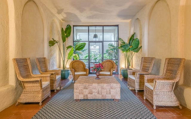 living area with tile patterned flooring and expansive windows