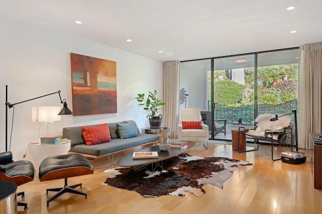 living room featuring light hardwood / wood-style flooring and floor to ceiling windows