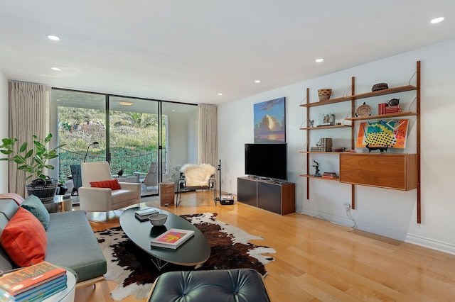 living room featuring light hardwood / wood-style flooring and floor to ceiling windows