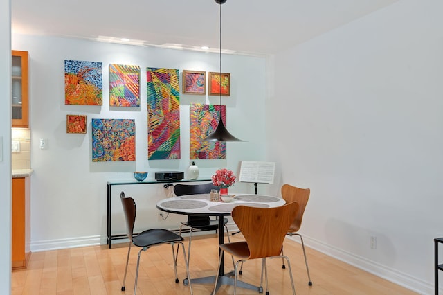 dining space with light hardwood / wood-style floors