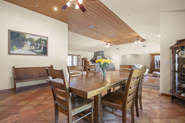 dining area with ceiling fan, dark tile patterned floors, lofted ceiling, and wood ceiling