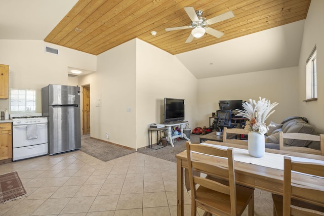 tiled dining room with ceiling fan, wood ceiling, and vaulted ceiling