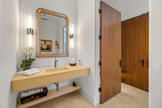 bathroom with sink and tile patterned flooring