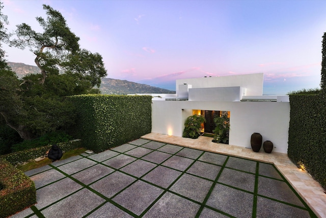 patio terrace at dusk with a mountain view