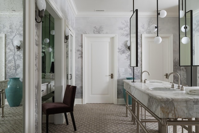 bathroom featuring ornamental molding and sink