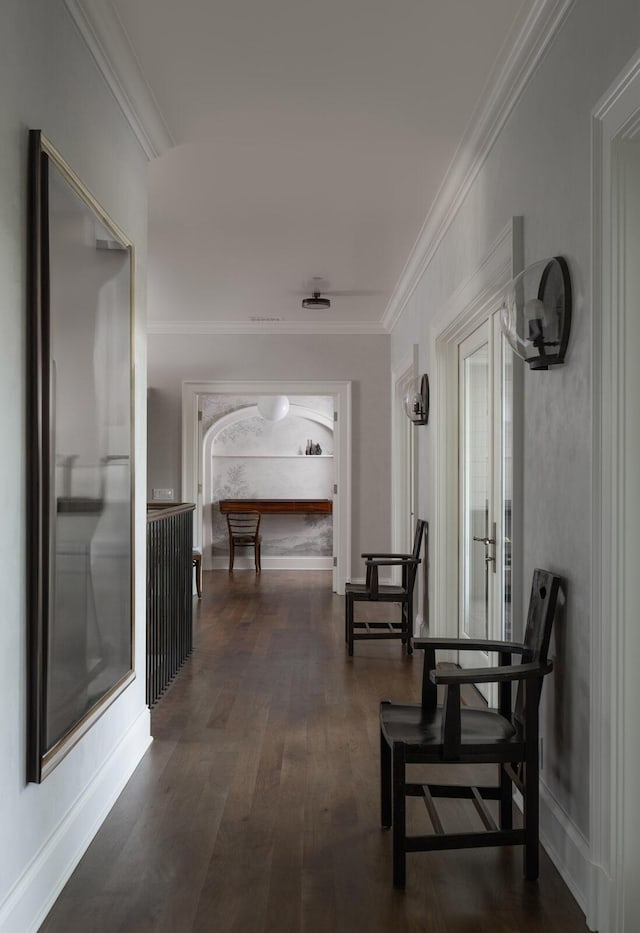 hall featuring crown molding, dark wood-type flooring, and a wealth of natural light