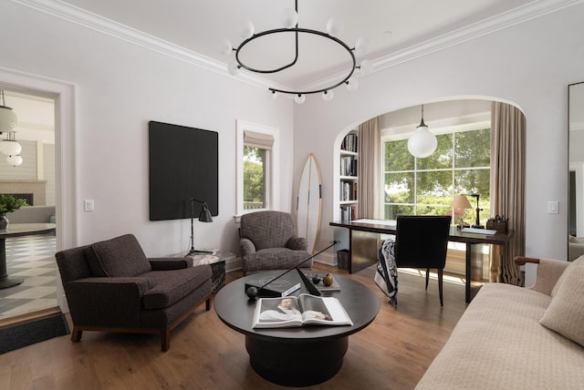 living room with crown molding, wood-type flooring, and a healthy amount of sunlight