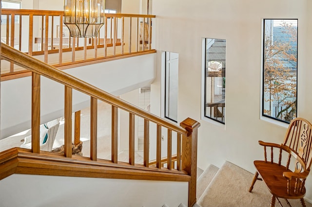 stairway with an inviting chandelier