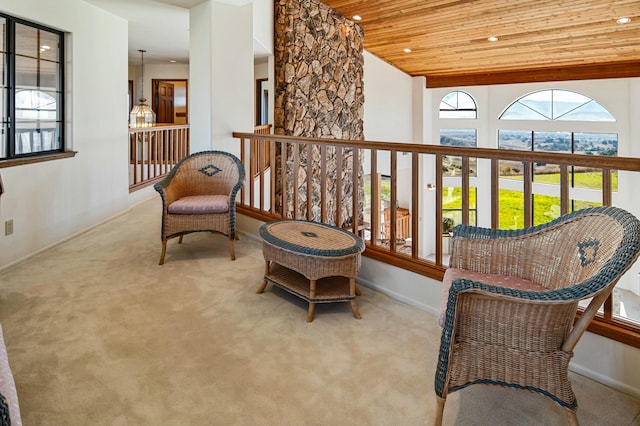 sitting room featuring wooden ceiling and light carpet