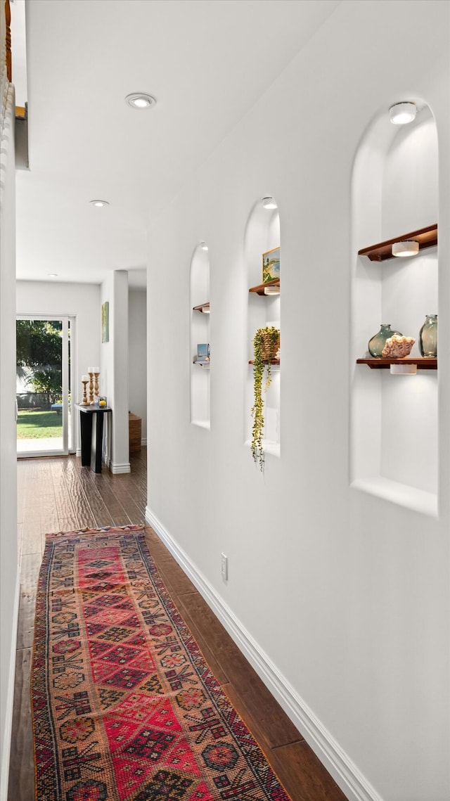 hallway featuring dark wood-type flooring