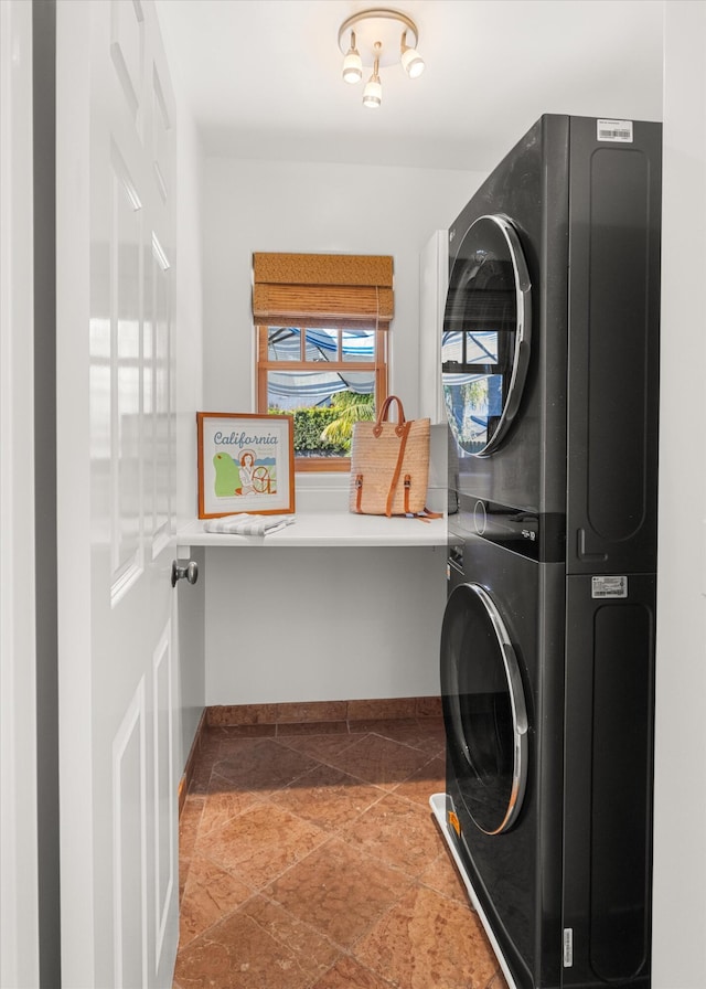 clothes washing area featuring stacked washer / drying machine