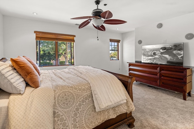 bedroom featuring multiple windows, carpet, and ceiling fan