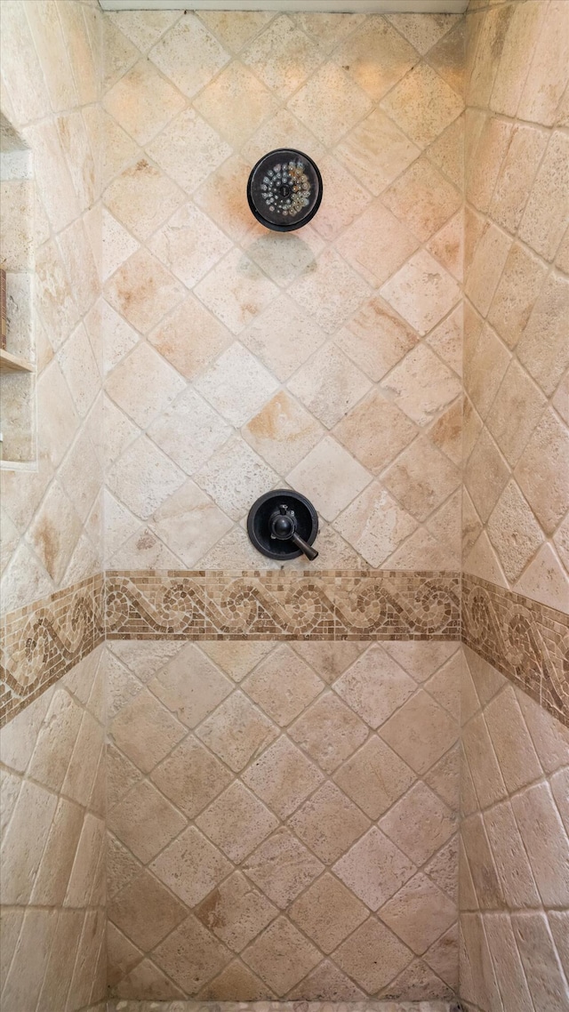 bathroom with tiled shower