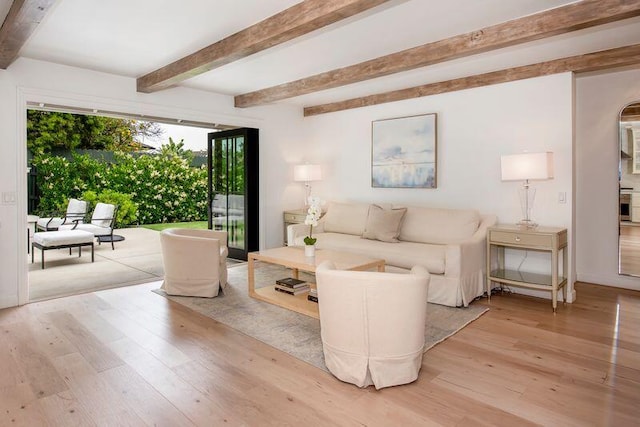 living room with beam ceiling and light hardwood / wood-style flooring