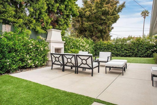 view of patio / terrace with an outdoor living space with a fireplace