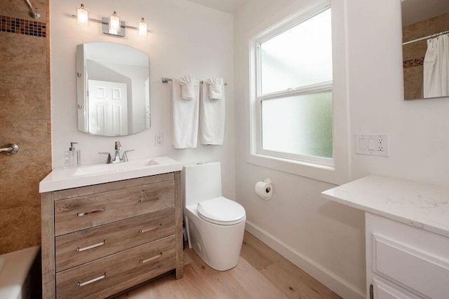 bathroom featuring curtained shower, vanity, wood-type flooring, and toilet