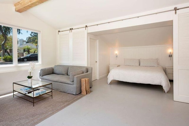 bedroom with concrete floors, lofted ceiling with beams, and a barn door