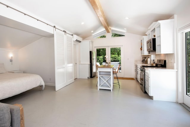 kitchen with white cabinetry, french doors, vaulted ceiling with beams, a wall mounted AC, and appliances with stainless steel finishes