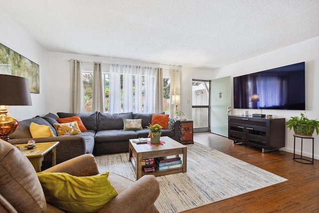 living room featuring a textured ceiling and dark wood-type flooring