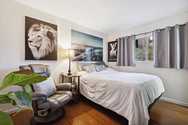 bedroom featuring a textured ceiling and dark wood-type flooring