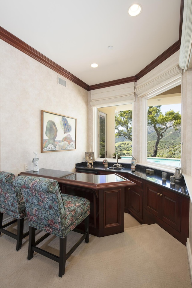 home office with light carpet and crown molding