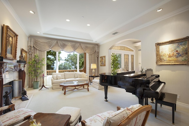 living area with crown molding, light colored carpet, and a tray ceiling