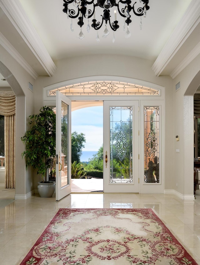 foyer with french doors and crown molding