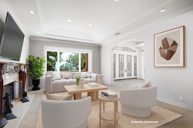 living room with ornamental molding, light colored carpet, and a raised ceiling