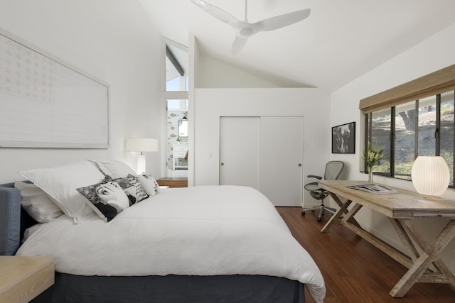 bedroom with lofted ceiling, dark wood-type flooring, a closet, and ceiling fan