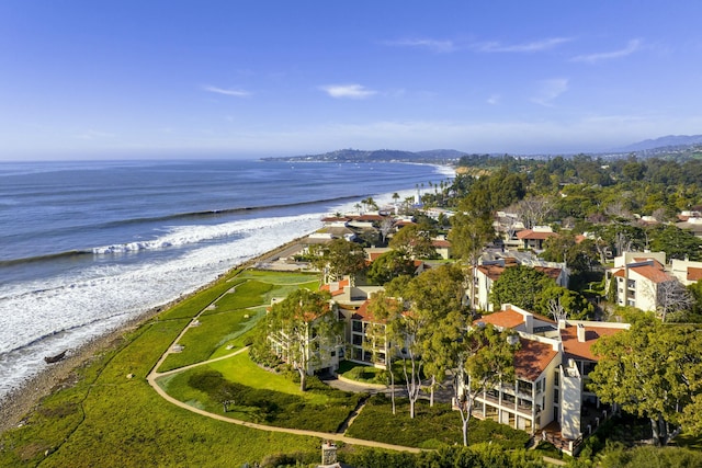 drone / aerial view featuring a water view and a view of the beach