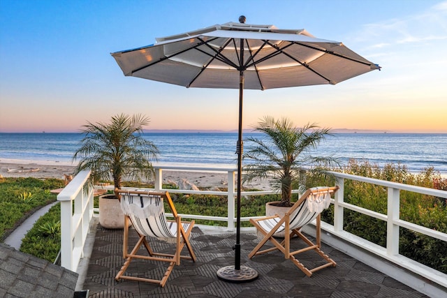 exterior space featuring a water view and a view of the beach