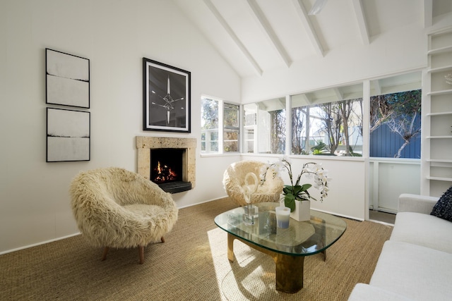 interior space with beam ceiling, carpet floors, high vaulted ceiling, and a premium fireplace