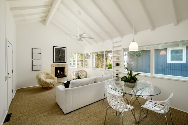 living room with carpet, ceiling fan, high vaulted ceiling, beamed ceiling, and a fireplace