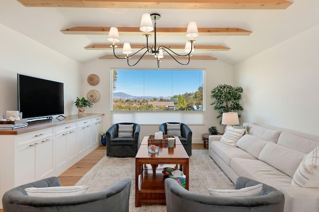 living room featuring an inviting chandelier, lofted ceiling with beams, and light wood-type flooring