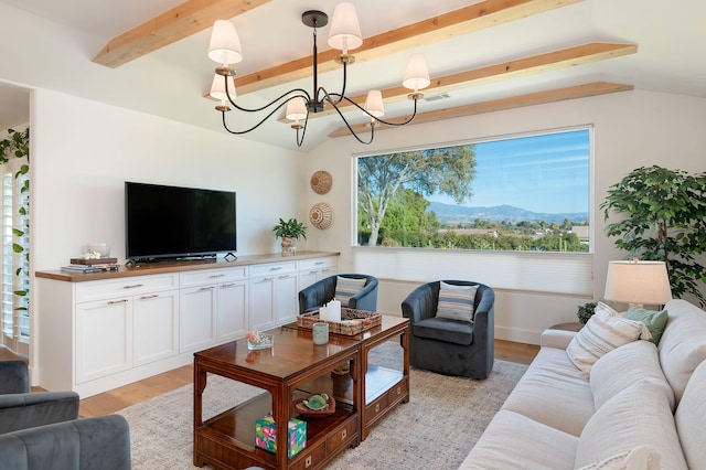 living room with light hardwood / wood-style flooring, lofted ceiling with beams, and a notable chandelier