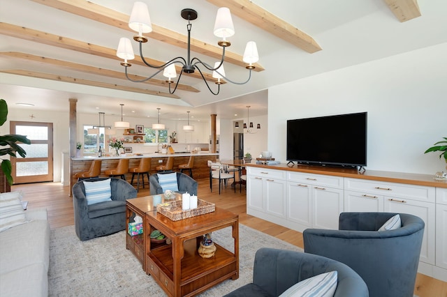 living room with beam ceiling, light hardwood / wood-style flooring, and a chandelier