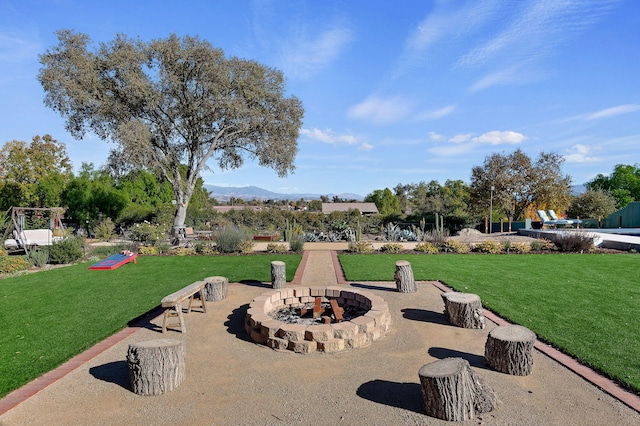 view of property's community with a lawn and a mountain view