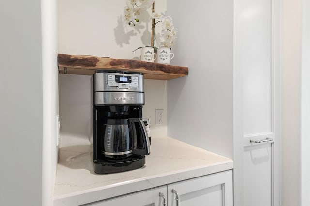 details with light stone counters and white cabinetry